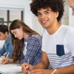 High-school students sitting in classroom in attentive fashion.